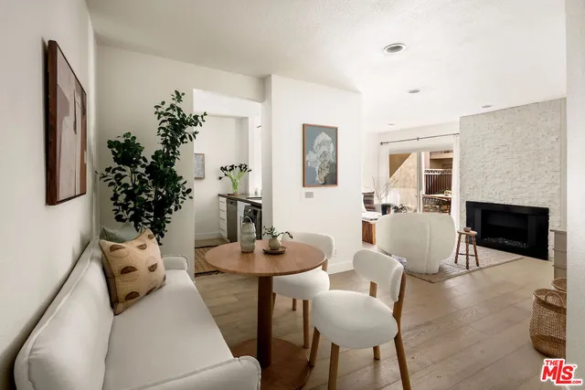 a living room with furniture potted plant and a fireplace