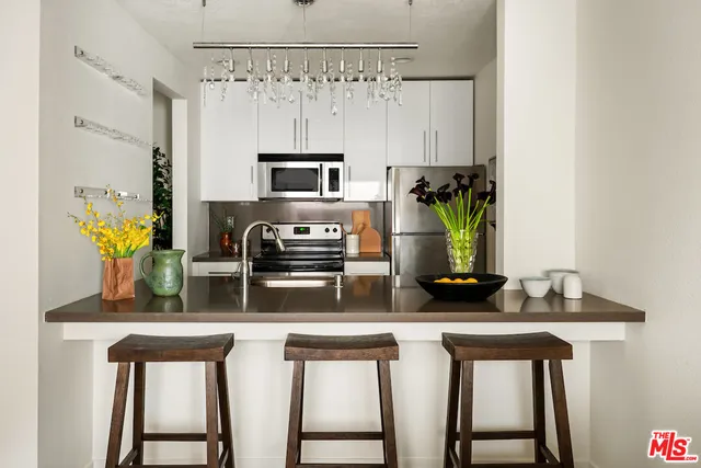 a kitchen with stainless steel appliances a sink and cabinets