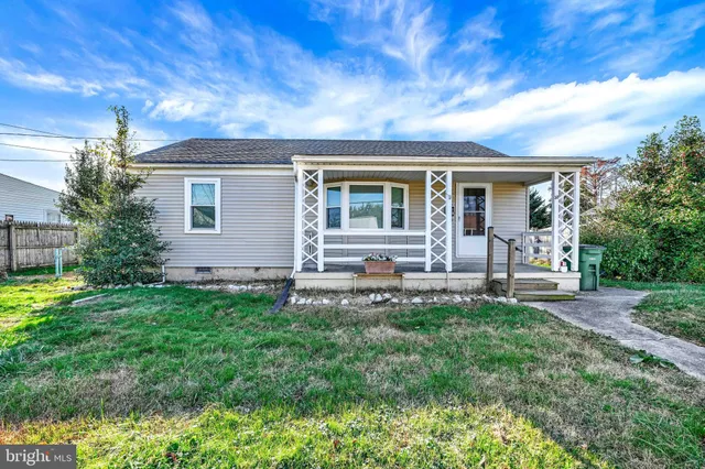 a front view of house with a garden