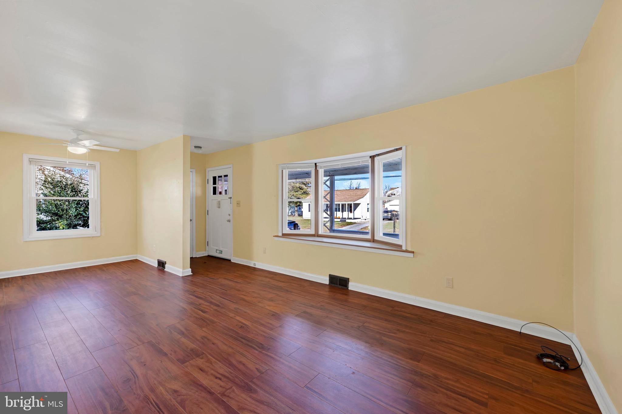 38 Mitchell Avenue Aberdeen, MD 21001 - Photo 3 of 15 an empty room with wooden floor and windows