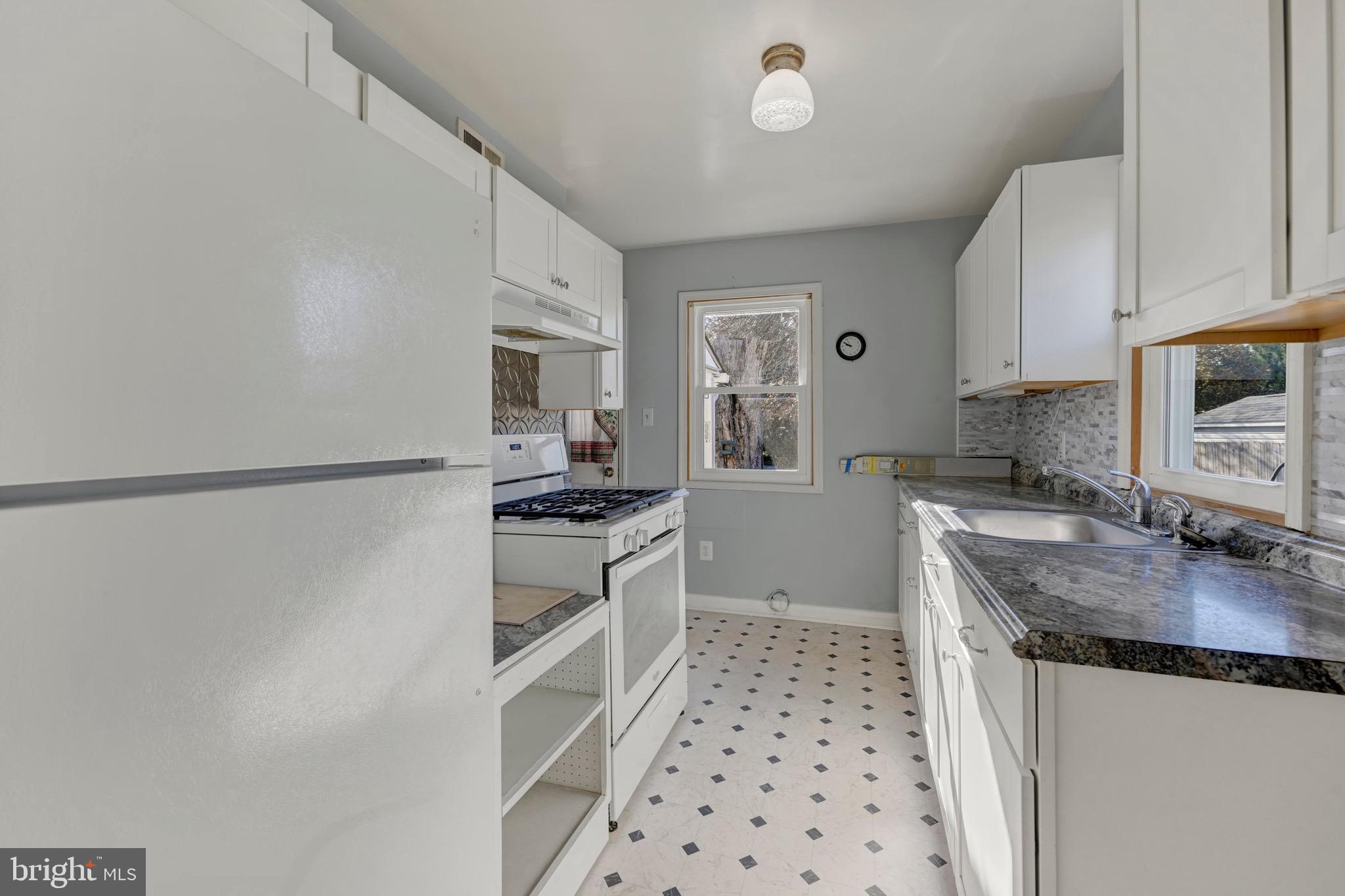 38 Mitchell Avenue Aberdeen, MD 21001 - Photo 7 of 15 a kitchen with granite countertop a sink stove and refrigerator