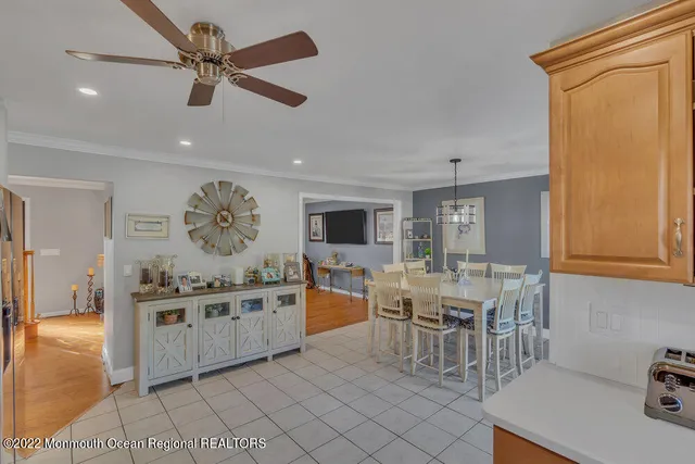 a view of a kitchen with a dining table and chairs