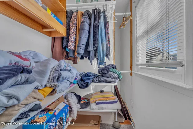 a spacious bedroom with a bed and a desk