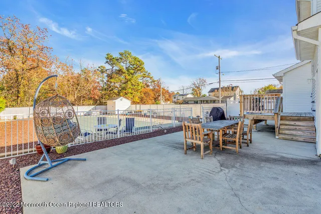 a view of a patio with a table and chairs