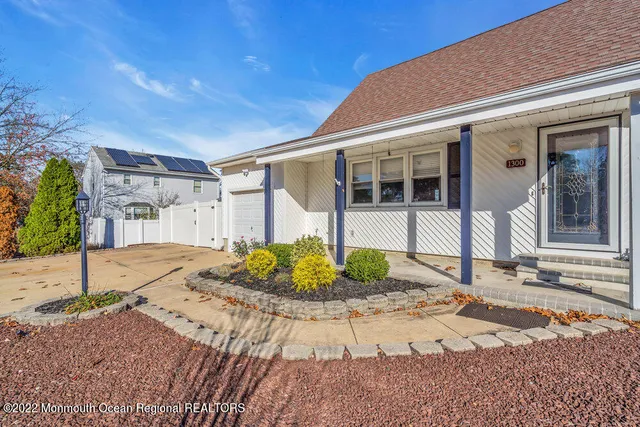 a living room with furniture and a ceiling fan