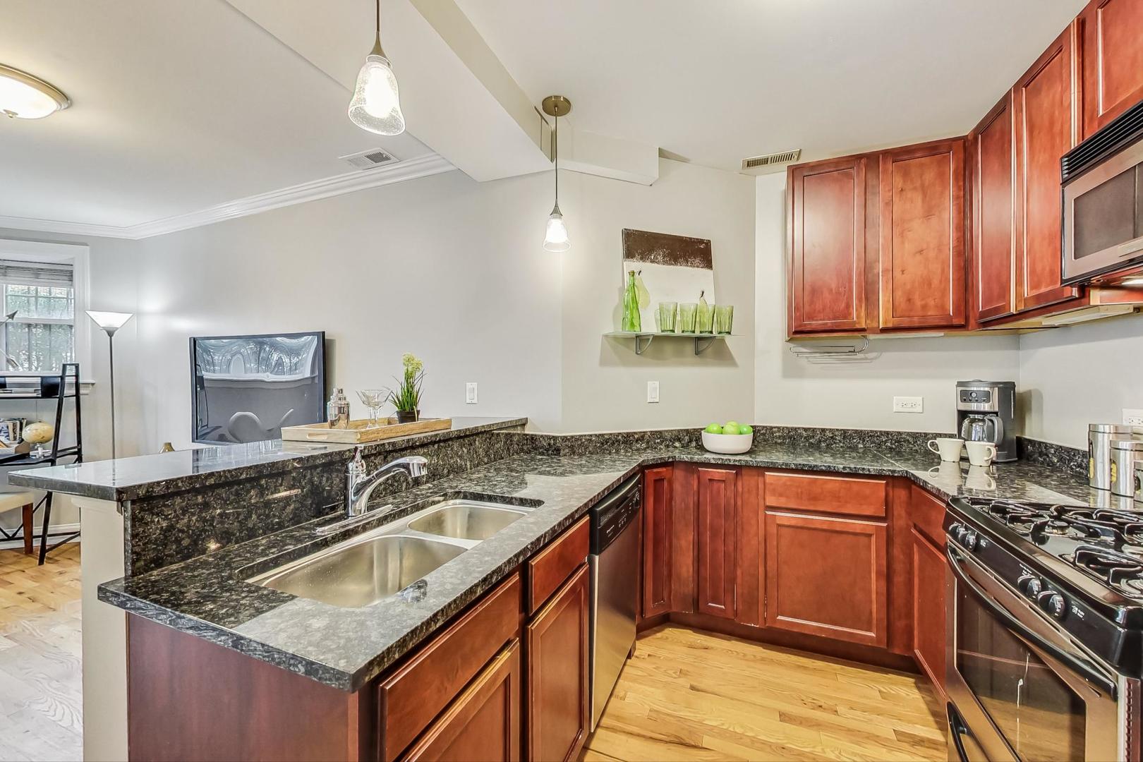 3734 North Clifton Avenue, Unit G Chicago, IL 60613 - Photo 11 of 27 a kitchen with stainless steel appliances granite countertop a sink stove and cabinets