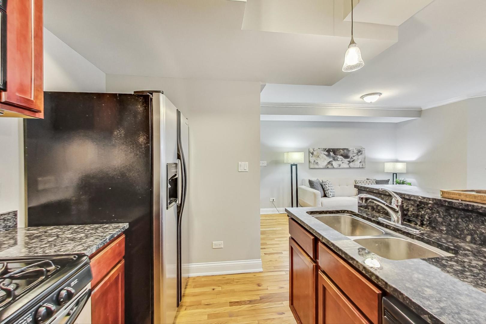 3734 North Clifton Avenue, Unit G Chicago, IL 60613 - Photo 12 of 27 a kitchen that has a sink a stove and a refrigerator