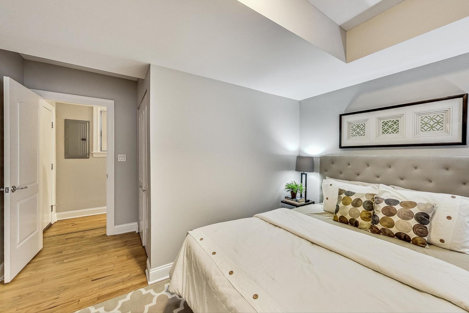 3734 North Clifton Avenue, Unit G Chicago, IL 60613 - Photo 15 of 27 a bedroom with a bed and a view of bathroom