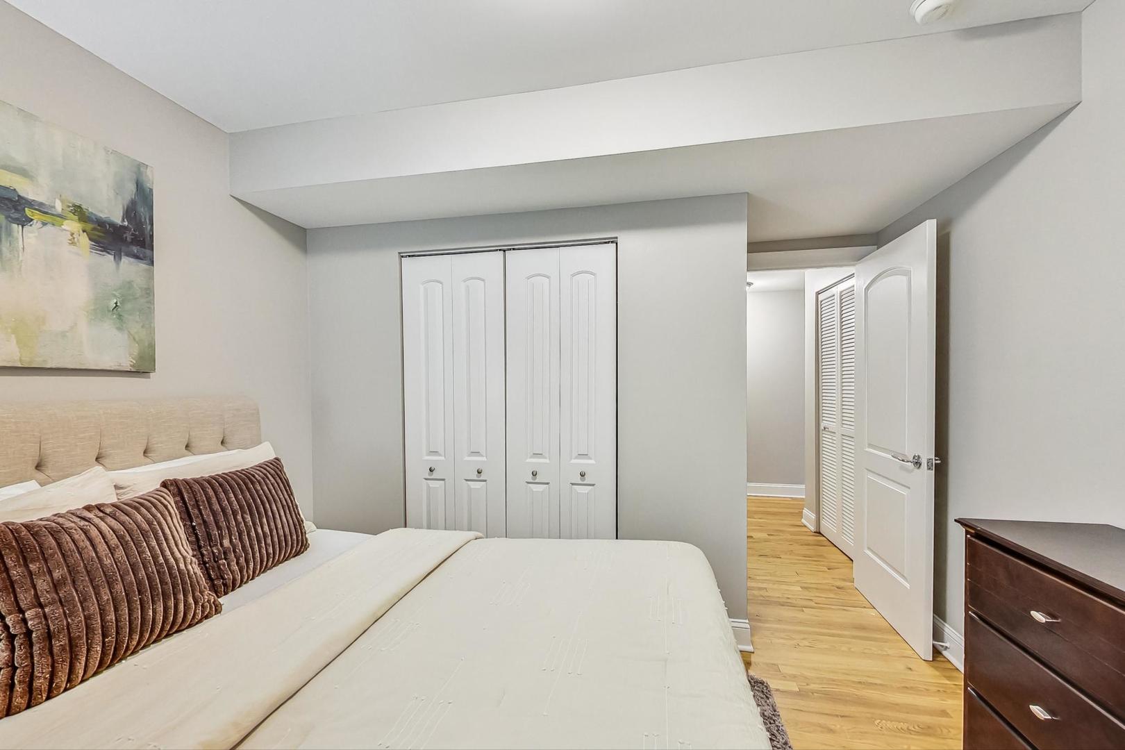 3734 North Clifton Avenue, Unit G Chicago, IL 60613 - Photo 18 of 27 a bedroom with a bed and a walk in closet