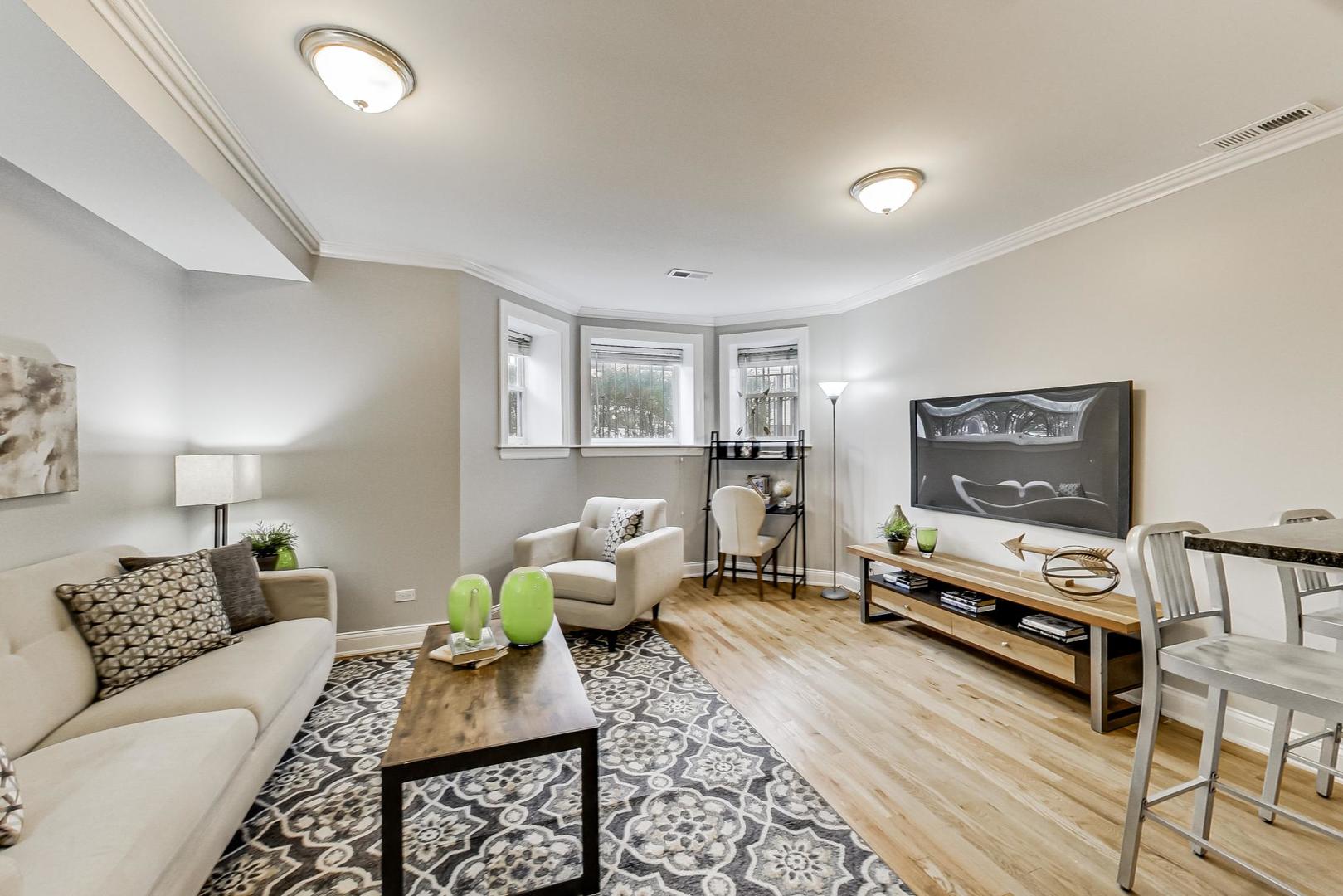 3734 North Clifton Avenue, Unit G Chicago, IL 60613 - Photo 6 of 27 a living room with furniture and a flat screen tv