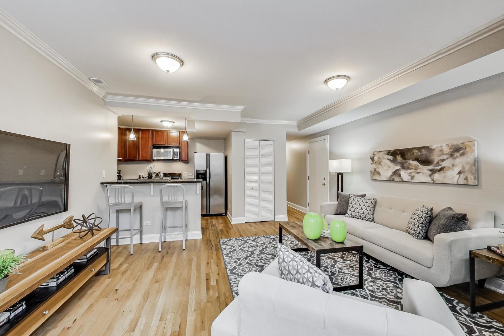 3734 North Clifton Avenue, Unit G Chicago, IL 60613 - Photo 8 of 27 a living room with furniture and a flat screen tv