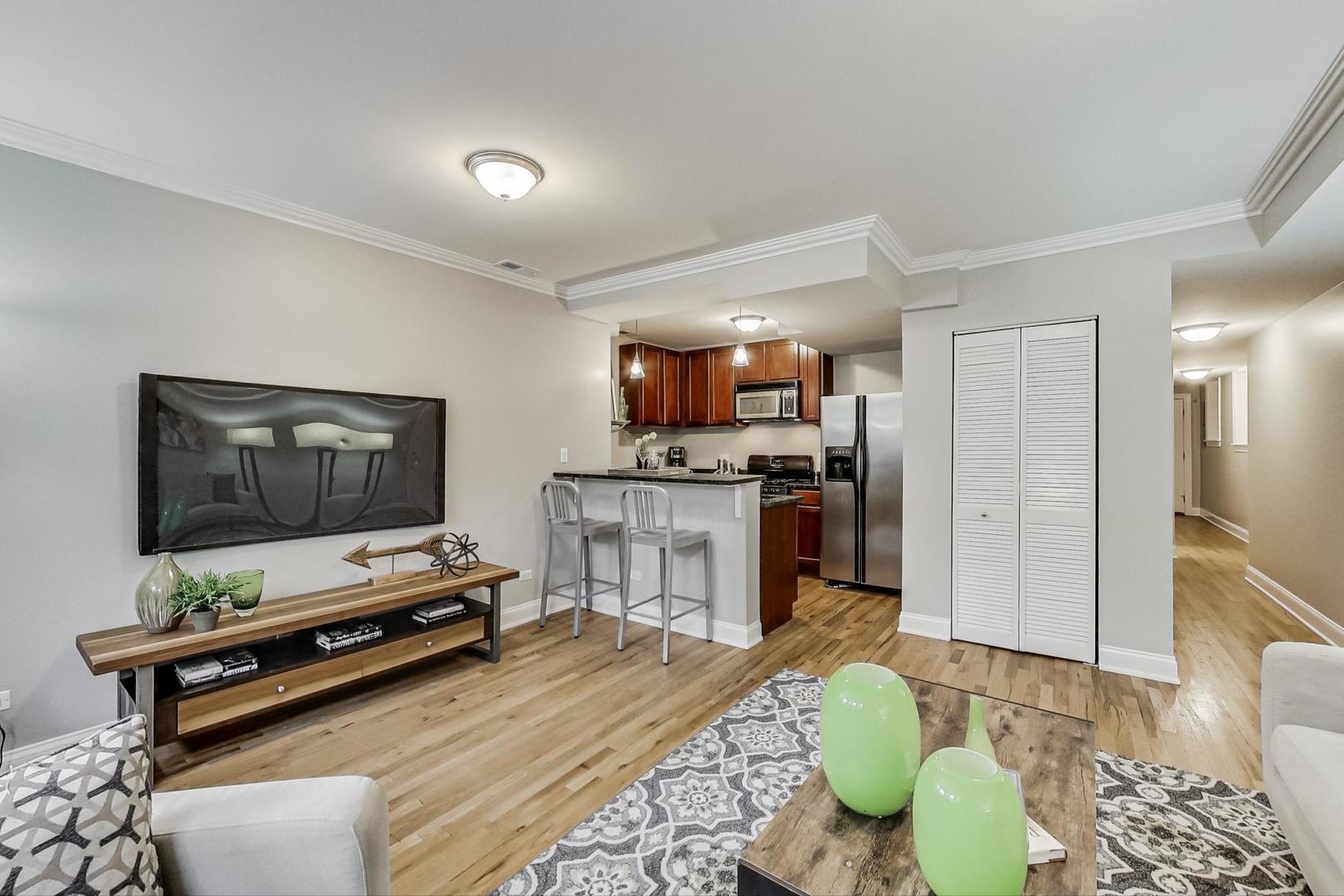 3734 North Clifton Avenue, Unit G Chicago, IL 60613 - Photo 9 of 27 a living room with furniture and a flat screen tv
