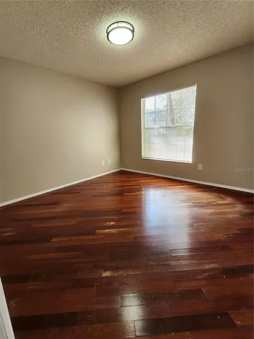 a view of room with window and wooden floor