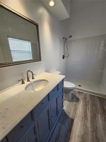 a bathroom with a sink a toilet and a mirror