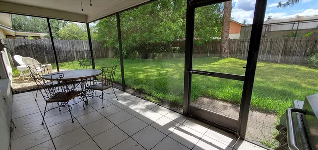 a view of a porch with chairs and backyard