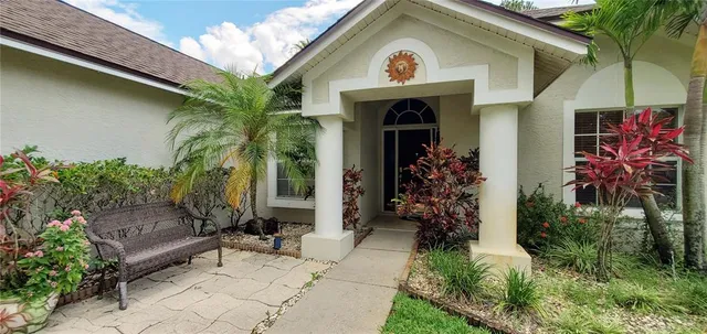 a view of a house with potted plants