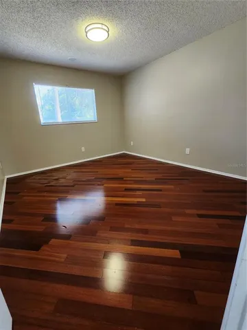 a view of room with wooden floor