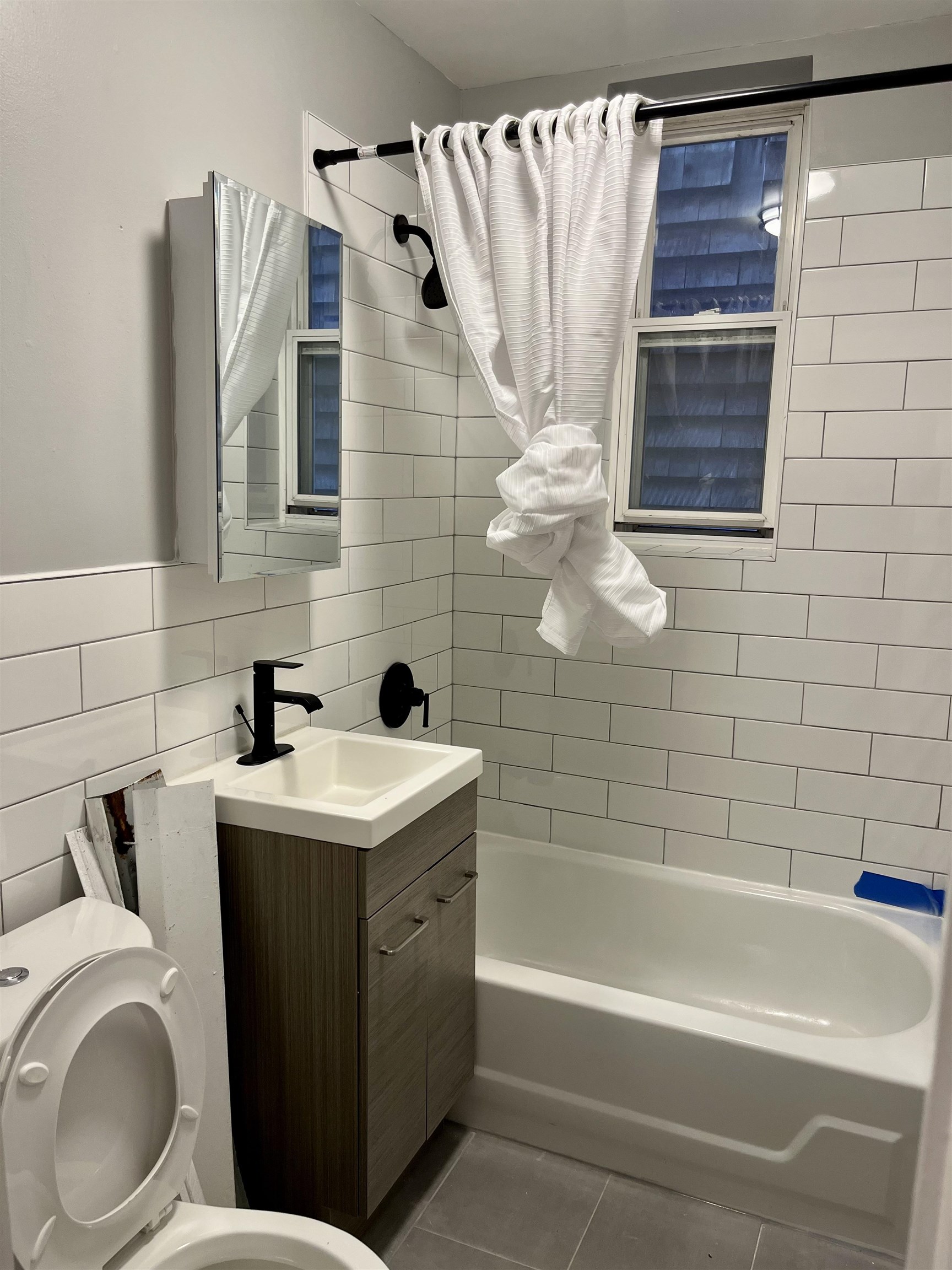 514 John F. Kennedy Boulevard, Unit 1 Bayonne, NJ 07002 - Photo 4 of 7 a bathroom with a sink a toilet and shower