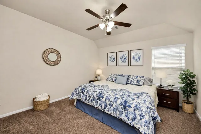 a bedroom with a large bed and a chandelier