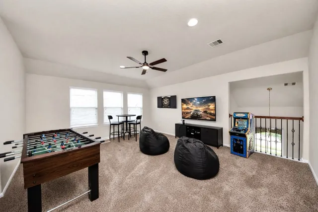 a living room with furniture a window and gym equipment
