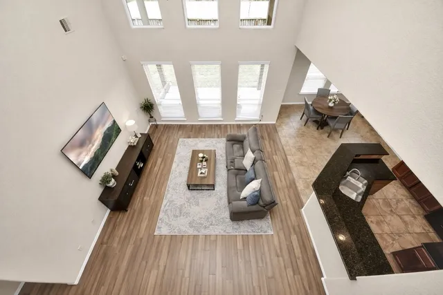 a view of a living room with furniture and wooden floor