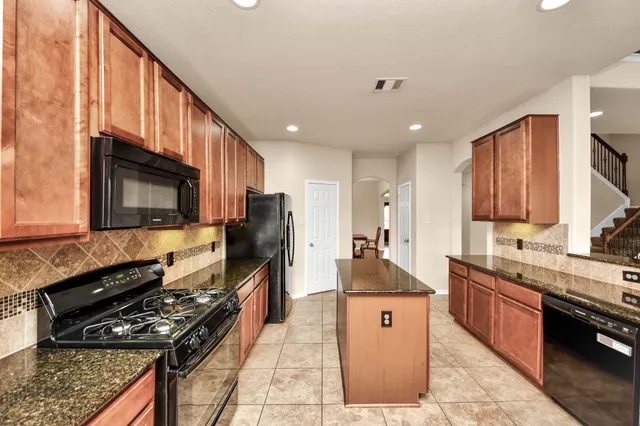 a kitchen with stainless steel appliances sink stove microwave and cabinets