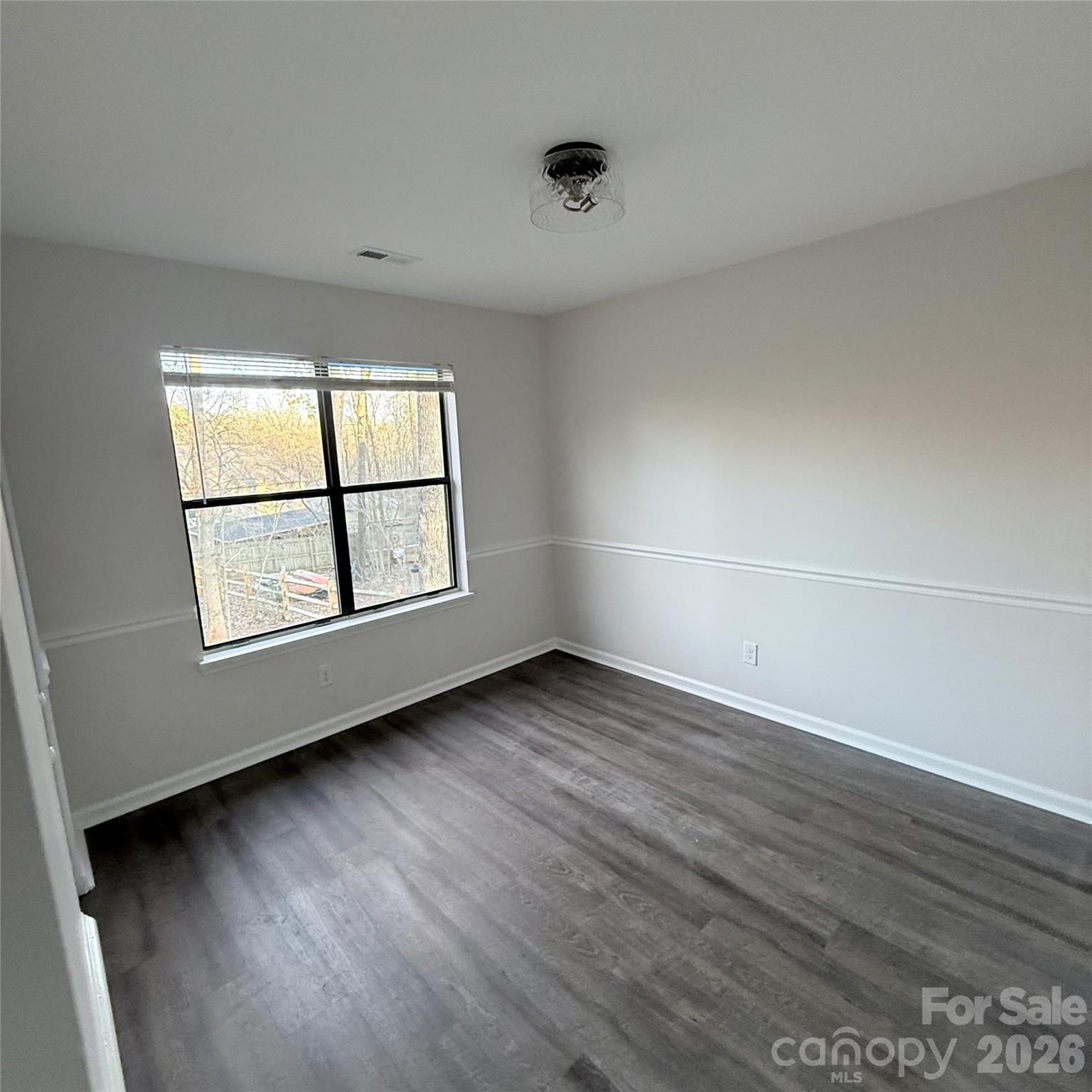 10129 Rockwood Road Charlotte, NC 28215 - Photo 15 of 36 an empty room with wooden floor and window