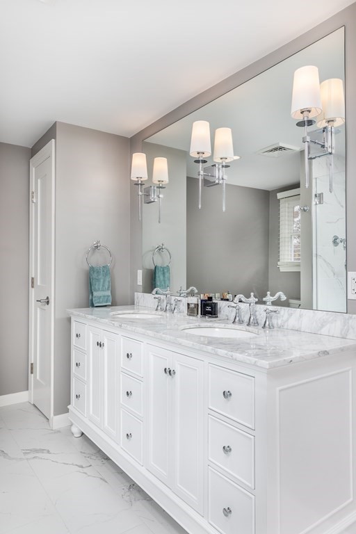 15 Carlton Road Marblehead, MA 01945 - Photo 21 of 37 a bathroom with a double vanity sink and a mirror