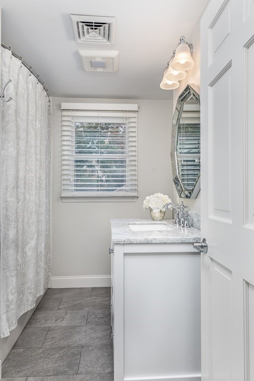 15 Carlton Road Marblehead, MA 01945 - Photo 26 of 37 a bathroom with a granite countertop sink a mirror and shower