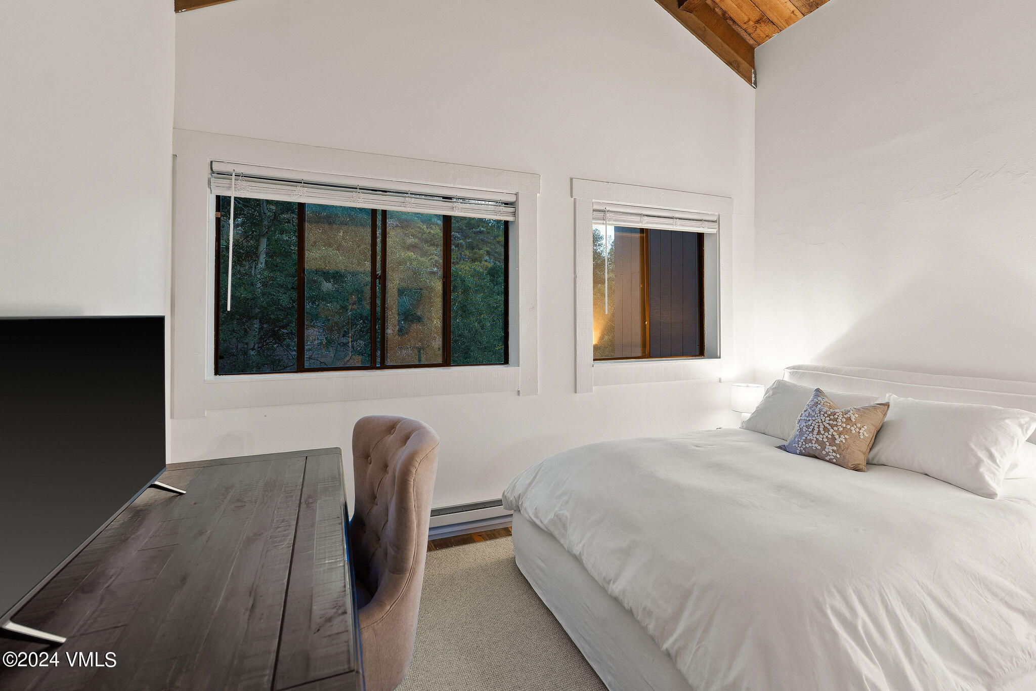 3094 Booth Falls Road, Unit 14 Vail, CO 81657 - Photo 16 of 36 a bedroom with a large bed and a large window