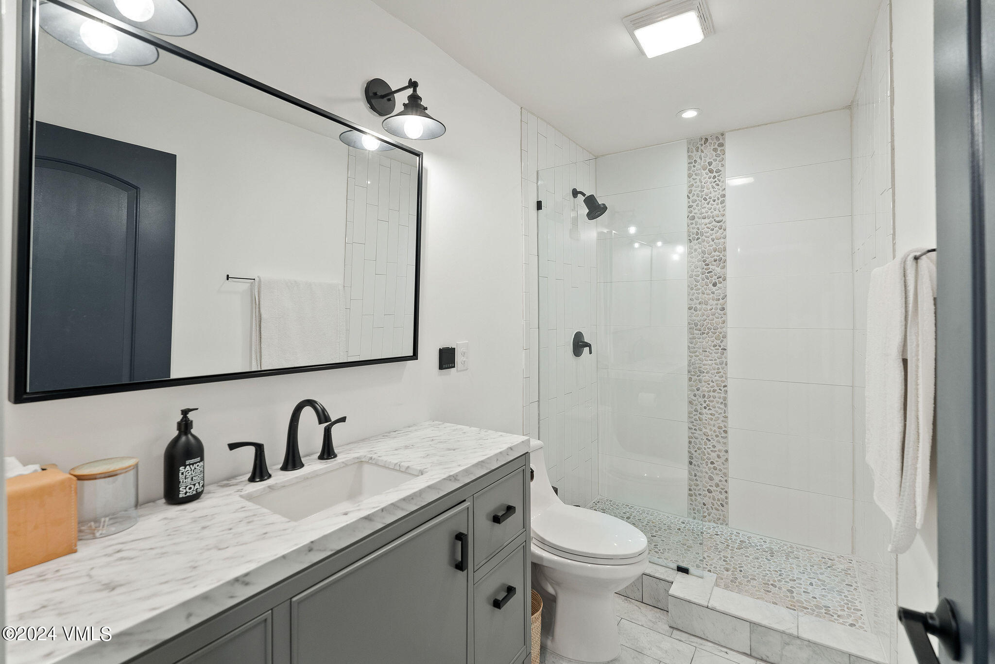 3094 Booth Falls Road, Unit 14 Vail, CO 81657 - Photo 19 of 36 a bathroom with a granite countertop sink toilet and shower