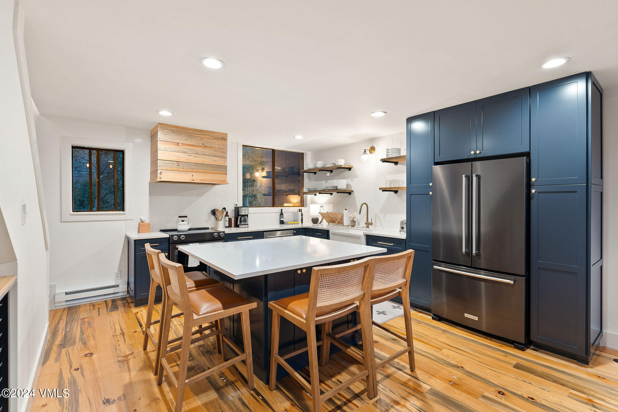 3094 Booth Falls Road, Unit 14 Vail, CO 81657 - Photo 8 of 36 a kitchen with stainless steel appliances granite countertop a refrigerator a sink a stove a dining table and chairs