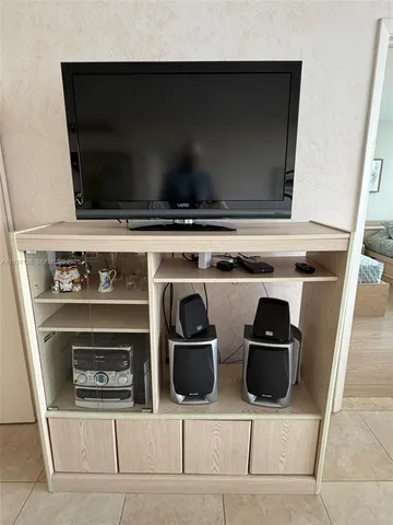 a living room with a stove and a microwave