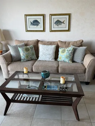 a living room with furniture and painting on the wall