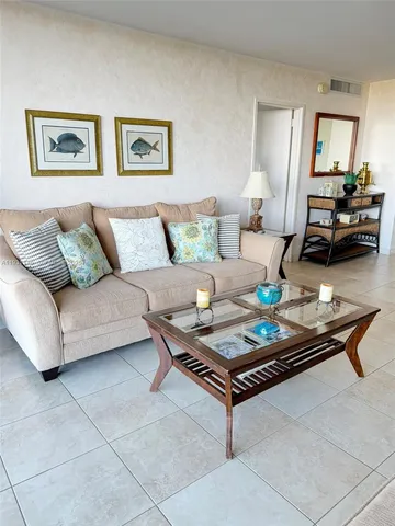 a living room with furniture and painting on the wall