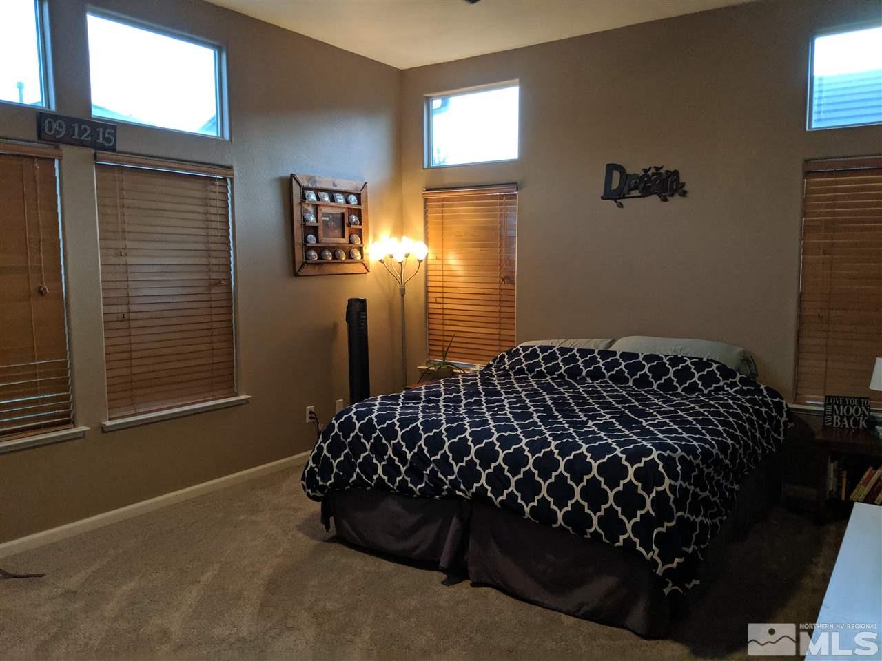 420 Pesaro Way Reno, NV 89521 - Photo 11 of 25 a bed sitting in a bedroom next to a window