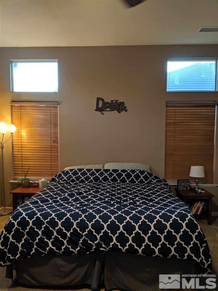 420 Pesaro Way Reno, NV 89521 - Photo 12 of 25 a bedroom with a bed and a window