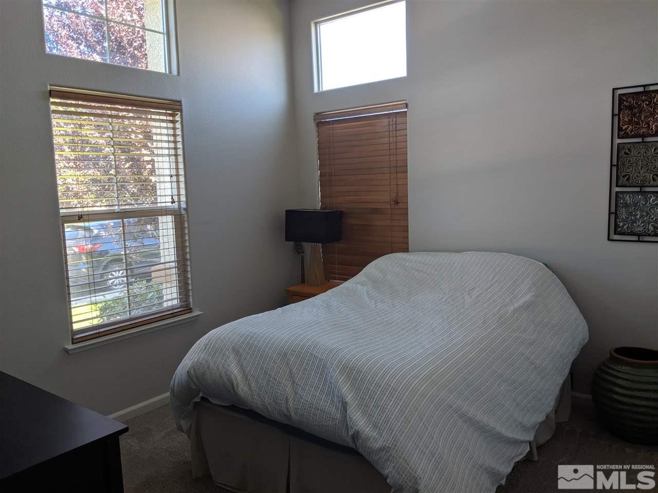 420 Pesaro Way Reno, NV 89521 - Photo 18 of 25 a bedroom with a bed and a window