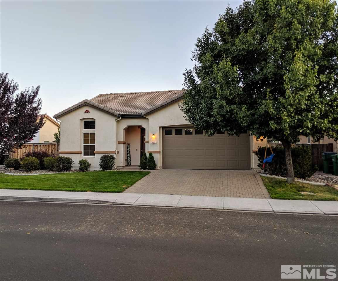 420 Pesaro Way Reno, NV 89521 - Photo 2 of 25 a front view of a house with a yard and garage