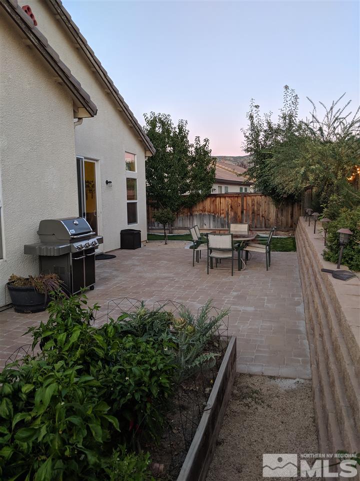 420 Pesaro Way Reno, NV 89521 - Photo 24 of 25 a view of a patio with table and chairs and potted plants