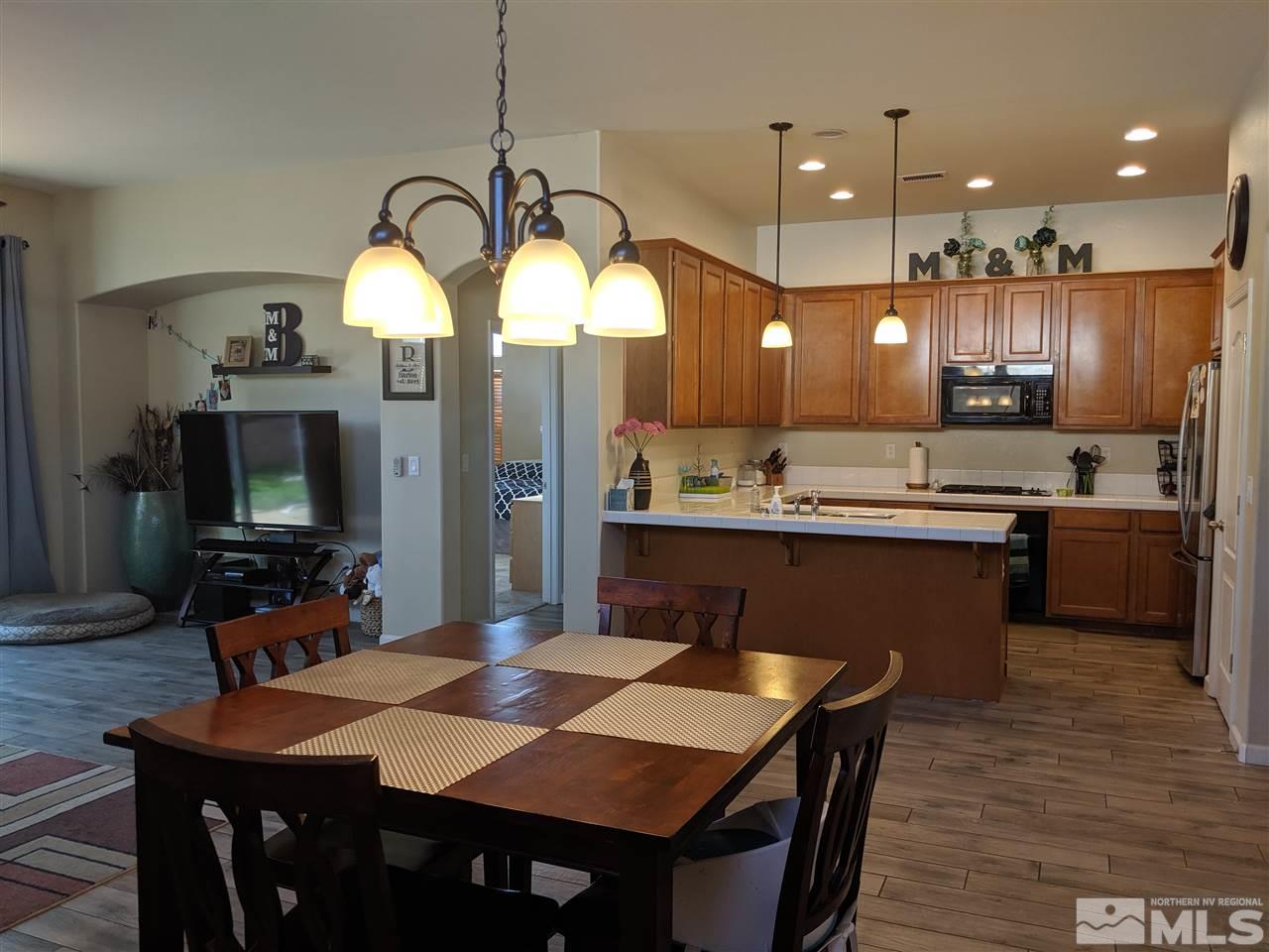 420 Pesaro Way Reno, NV 89521 - Photo 3 of 25 a kitchen with a table and chairs in it