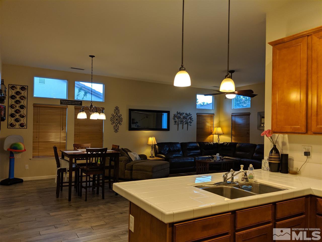 420 Pesaro Way Reno, NV 89521 - Photo 6 of 25 a kitchen with a table chairs and a chandelier
