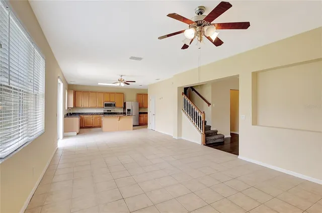 a view of a livingroom with furniture and a kitchen view