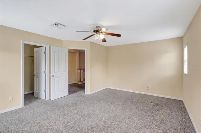 a view of a livingroom with a ceiling fan and window