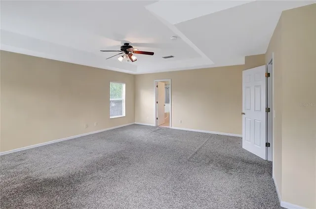 a view of empty room with ceiling fan