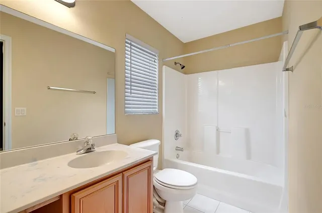 a bathroom with a sink a toilet a mirror and shower