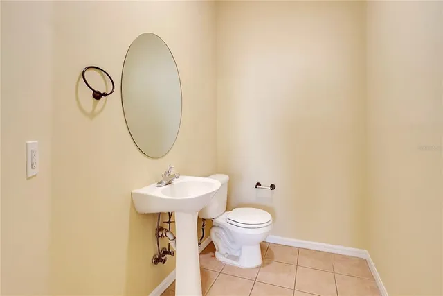 a bathroom with a sink toilet and a mirror