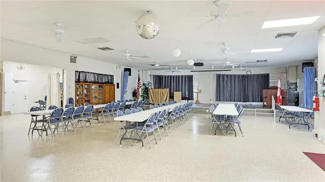 a dining room with furniture and a chandelier