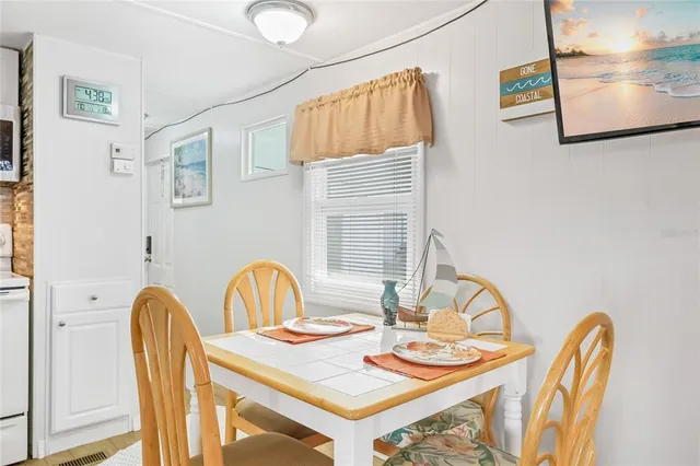 a dining room with furniture and wooden floor