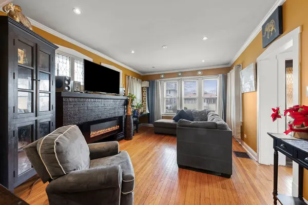 a living room with furniture a flat screen tv and a fireplace